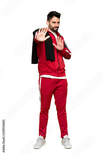 Full-length shot of Handsome sportman is a little bit nervous and scared stretching hands to the front on isolated white background
