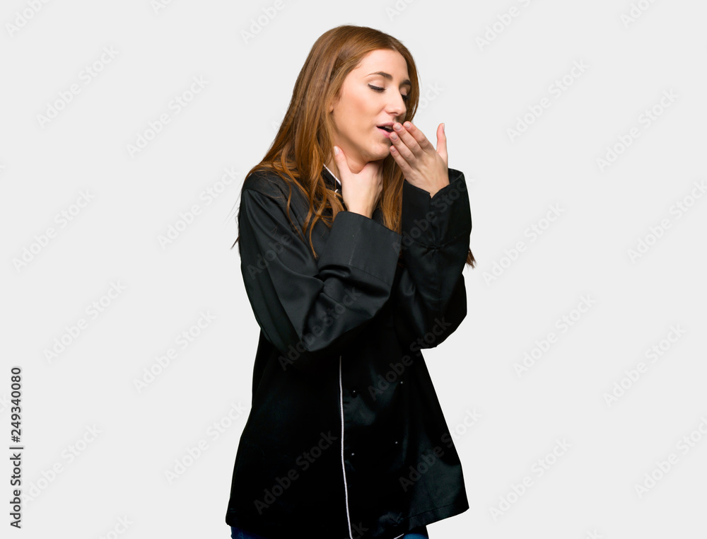Young redhead chef woman is suffering with cough and feeling bad on isolated grey background Young redhead chef woman is suffering with cough and feeling bad on isolated grey background