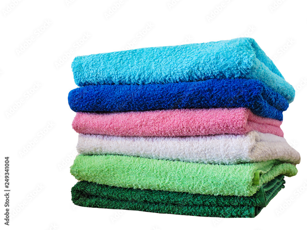 Stack of colorful bath towels on white background.Pile of rainbow colored towels isolated.Top view.Hygiene, fabric,spa and textile concept. Stack of colorful bath towels on white background.Pile of rainbow colored towels isolated.Top view.Hygiene, fabric,spa and textile concept.