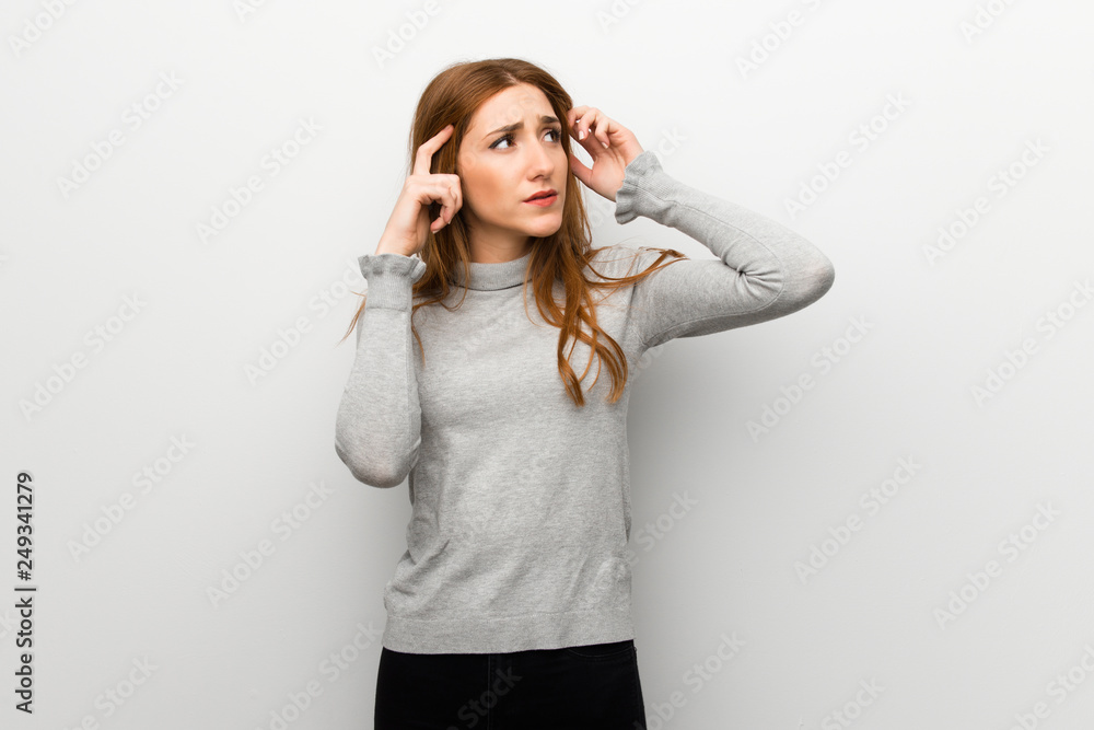 Redhead girl over white wall having doubts and thinking Redhead girl over white wall having doubts and thinking