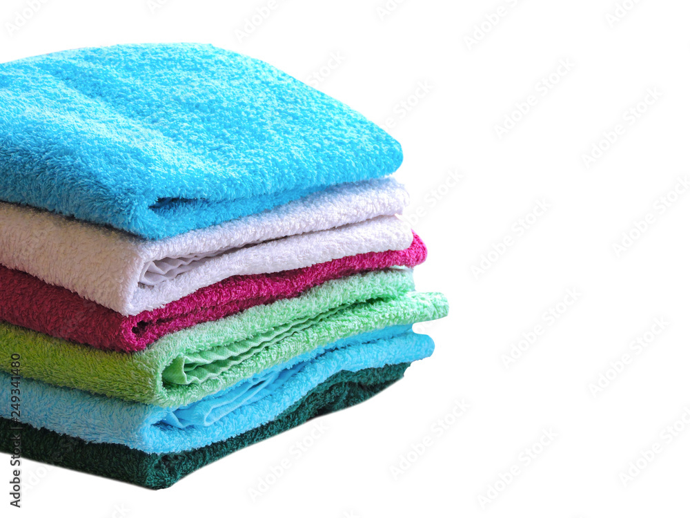 Stack of colorful bath towels on white background.Pile of rainbow colored towels isolated.Top view.Hygiene, fabric,spa and textile concept. Stack of colorful bath towels on white background.Pile of rainbow colored towels isolated.Top view.Hygiene, fabric,spa and textile concept.