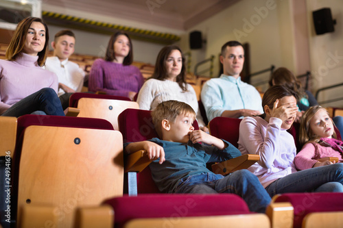 Group of people watching movie attentively