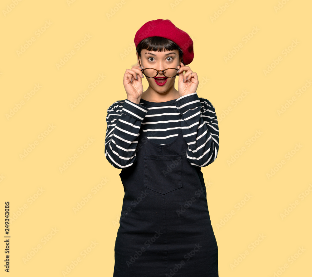Young woman with beret with glasses and surprised Young woman with beret with glasses and surprised