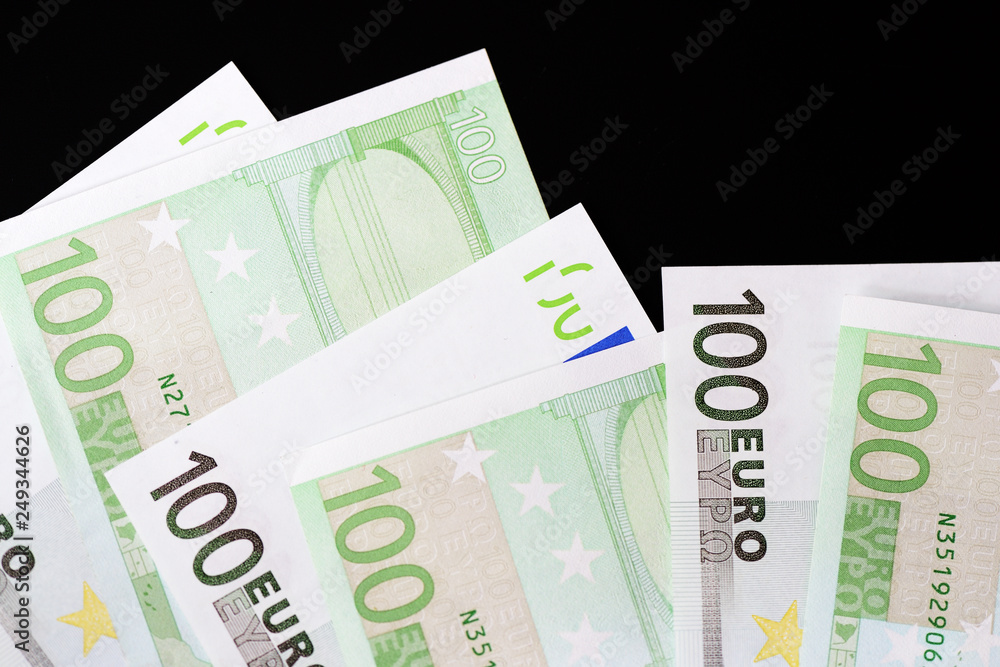 One Hundred euro banknotes on a dark background close up One Hundred euro banknotes on a dark background close up