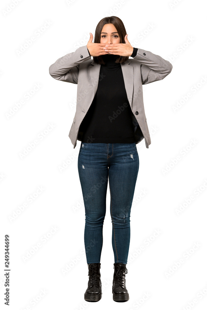 A full-length shot of a Young business woman covering mouth with hands for saying something inappropriate over isolated white background A full-length shot of a Young business woman covering mouth with hands for saying something inappropriate over isolated white background