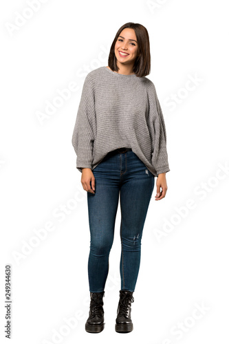 A full-length shot of a Young woman smiling over isolated white background photo