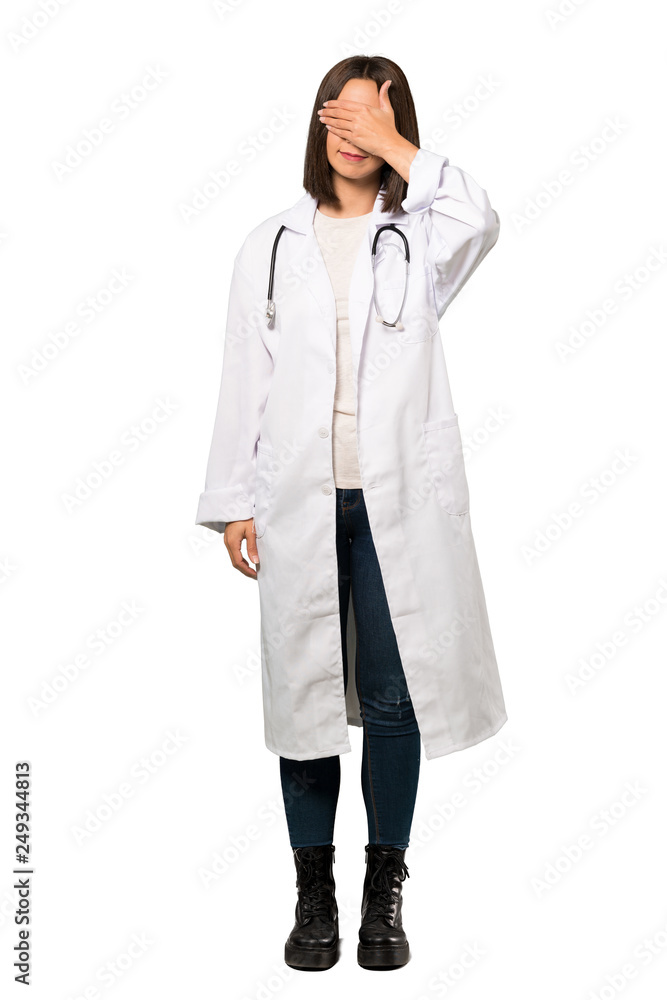 A full-length shot of a Young doctor woman covering eyes by hands. Do not want to see something over isolated white background A full-length shot of a Young doctor woman covering eyes by hands. Do not want to see something over isolated white background