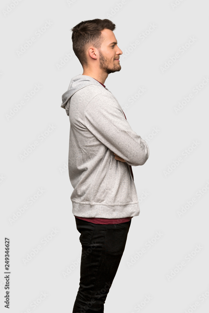 Man with sweatshirt in lateral position over grey background Man with sweatshirt in lateral position over grey background