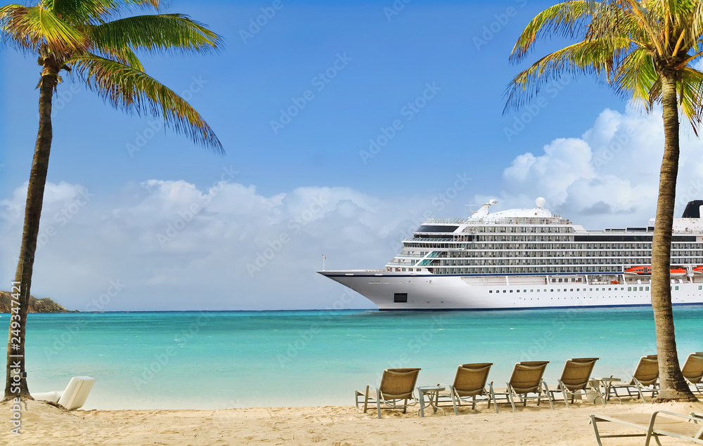 View from tropical beach on cruise ship sailing to port 