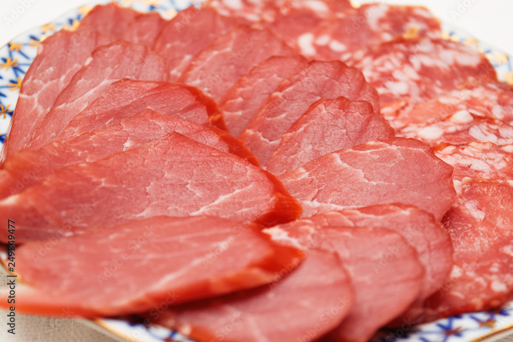 cold cuts of beams and salami on a plate, selective focus cold cuts of beams and salami on a plate, selective focus