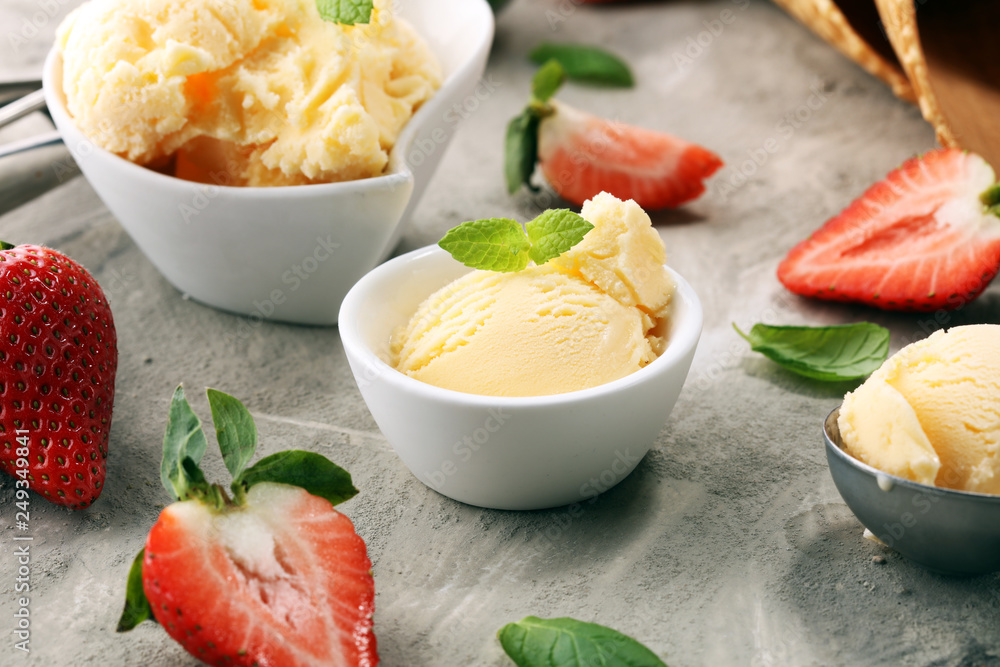 Vanilla ice cream scoop with fresh strawberries and icecream cones Vanilla ice cream scoop with fresh strawberries and icecream cones