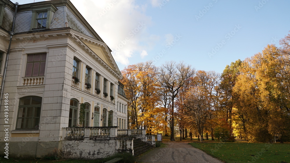19th-century building against the background of autumn trees