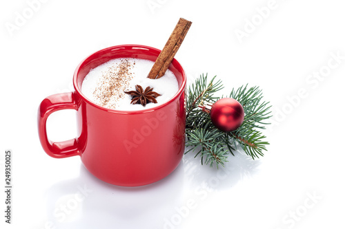 eggnog cocktail in red mug arranged with christmas decoration