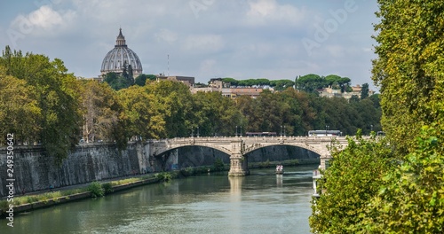 view on Bridge Giuseppe Mazzini and dome of Vatican cathedral  from embankment of Tiber river in Rome, Italy photo