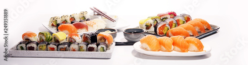 close up of sashimi sushi set with chopsticks and soy - sushi roll with salmon and sushi roll with smoked eel