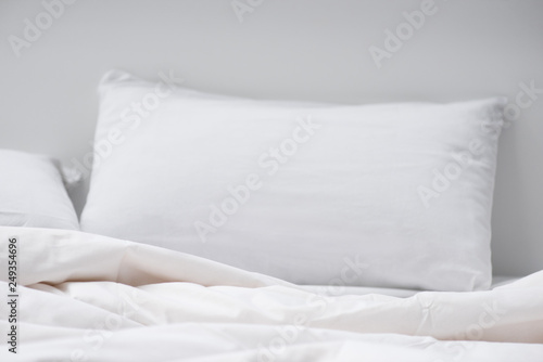 selective focus of bed with white pillow and blanket