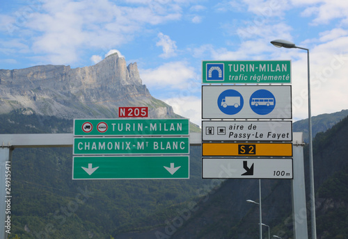 road sign on the border between Italy and France and directions photo