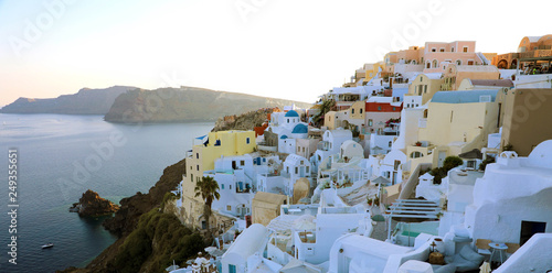 SANTORINI, GREECE - JULY 19, 2018: Stunning panoramic view of Santorini island with white houses and blue domes on famous Greek resort Oia, Greece, Europe.