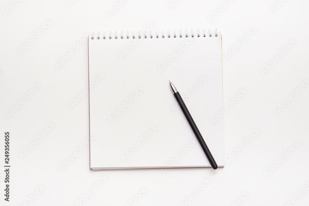 Spiral blank notepad and black pen on white background.Top view Spiral blank notepad and black pen on white background.Top view