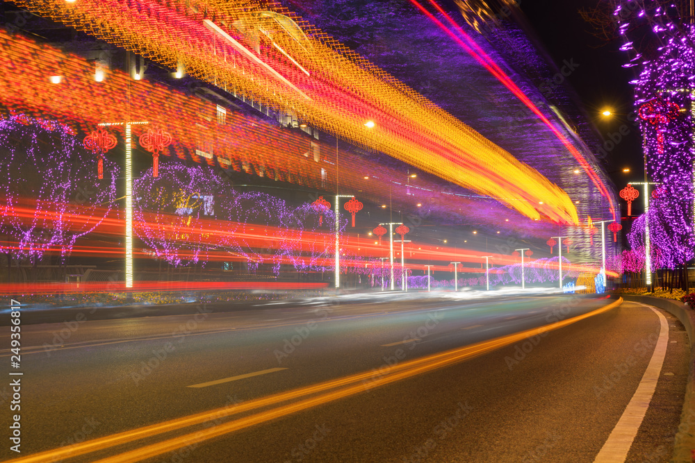 Highway with Colorful Lights in Spring Festival.abstract image of blur motion of cars on the city road at night,Modern urban architecture in Chongqing, China Highway with Colorful Lights in Spring Festival.abstract image of blur motion of cars on the city road at night,Modern urban architecture in Chongqing, China
