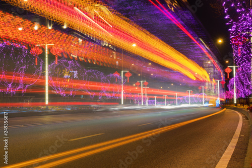 Highway with Colorful Lights in Spring Festival.abstract image of blur motion of cars on the city road at night,Modern urban architecture in Chongqing, China