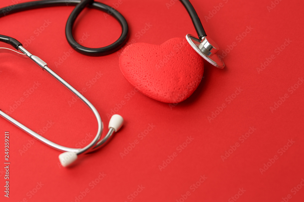 stethoscope on a red background with a red heart, free space, concept medicine and a doctor's office stethoscope on a red background with a red heart, free space, concept medicine and a doctor's office