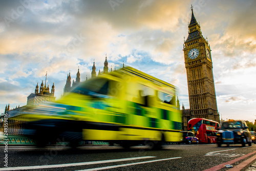 An ambulance drives over the Westminister Bridge. In the background the Big Ben. photo