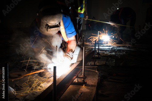 Welder, welding sparks in the construction and manufacturing in factory