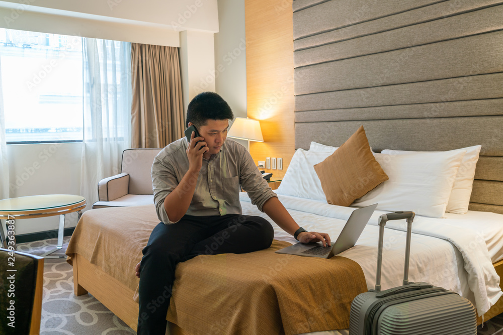 Businessman using a laptop in the hotel room Businessman using a laptop in the hotel room