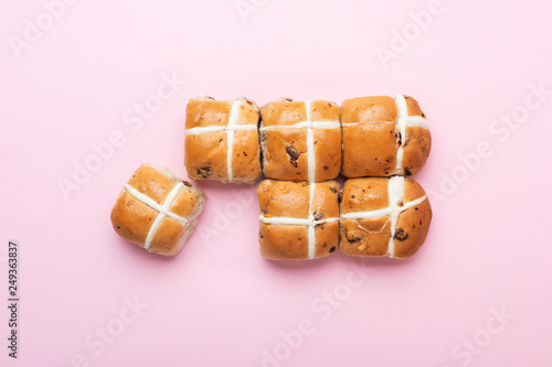 Six hot cross buns, traditional British Easter food on pink background, top view, selective focus photo