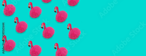 Pink Flamingo toy pattern on trendy blue background with copy space. Flamingo time for rest and relax. Creative layout summer concept for gift birthday party. Minimal style, flat lay, top view