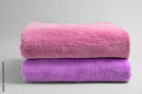 Soft bath towels on grey background