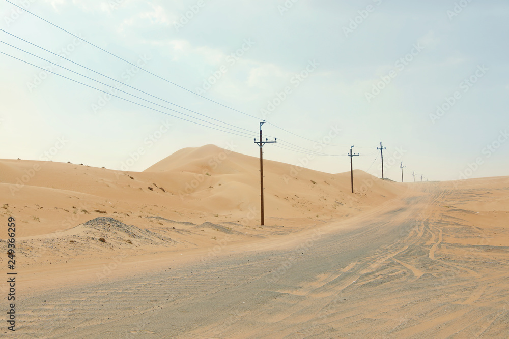 Electricity transmission line near road in desert