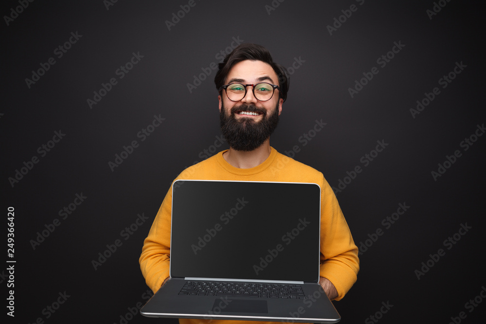 Glad man showing modern laptop Glad man showing modern laptop