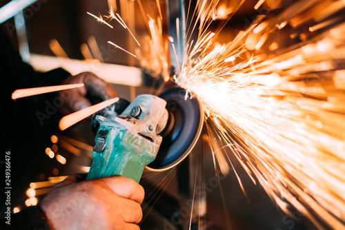 Fotografie, Tablou construction industry details - metalworker using disc grinder for cutting metal