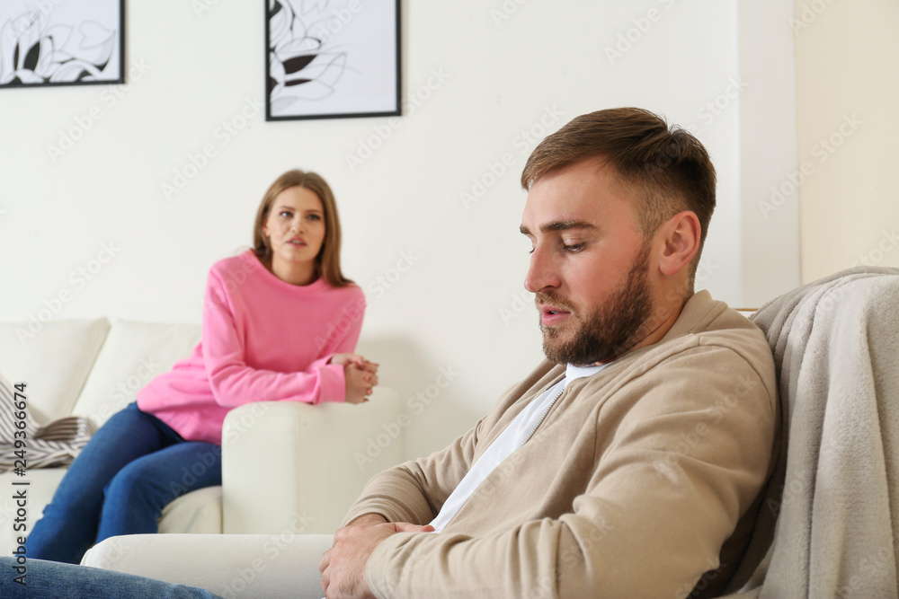 Young couple ignoring each other after argument in living room. Relationship problems Young couple ignoring each other after argument in living room. Relationship problems
