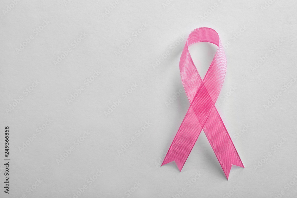 Pink ribbon on white background, top view with space for text. Breast cancer awareness concept Pink ribbon on white background, top view with space for text. Breast cancer awareness concept