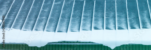 Iron roof on house with snow photo