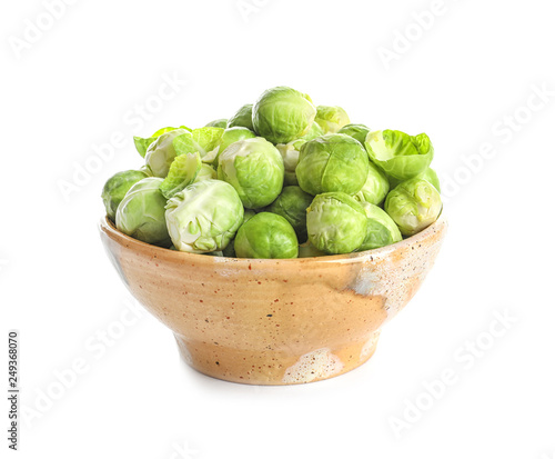 Bowl of fresh Brussels sprouts isolated on white
