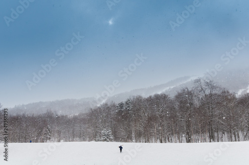 Solitary skier hiking towards the ski trails.