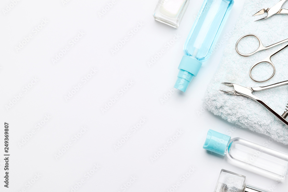 Set of tools for manicure on a towel and a set of nail polishes isolated on white background. Insulation. Set of tools for manicure on a towel and a set of nail polishes isolated on white background. Insulation.