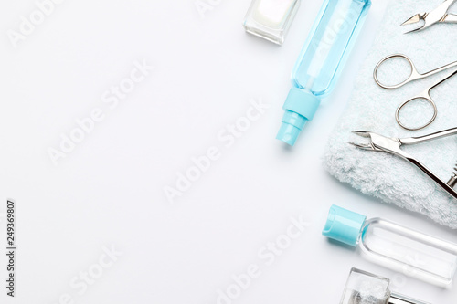 Set of tools for manicure on a towel and a set of nail polishes isolated on white background. Insulation.