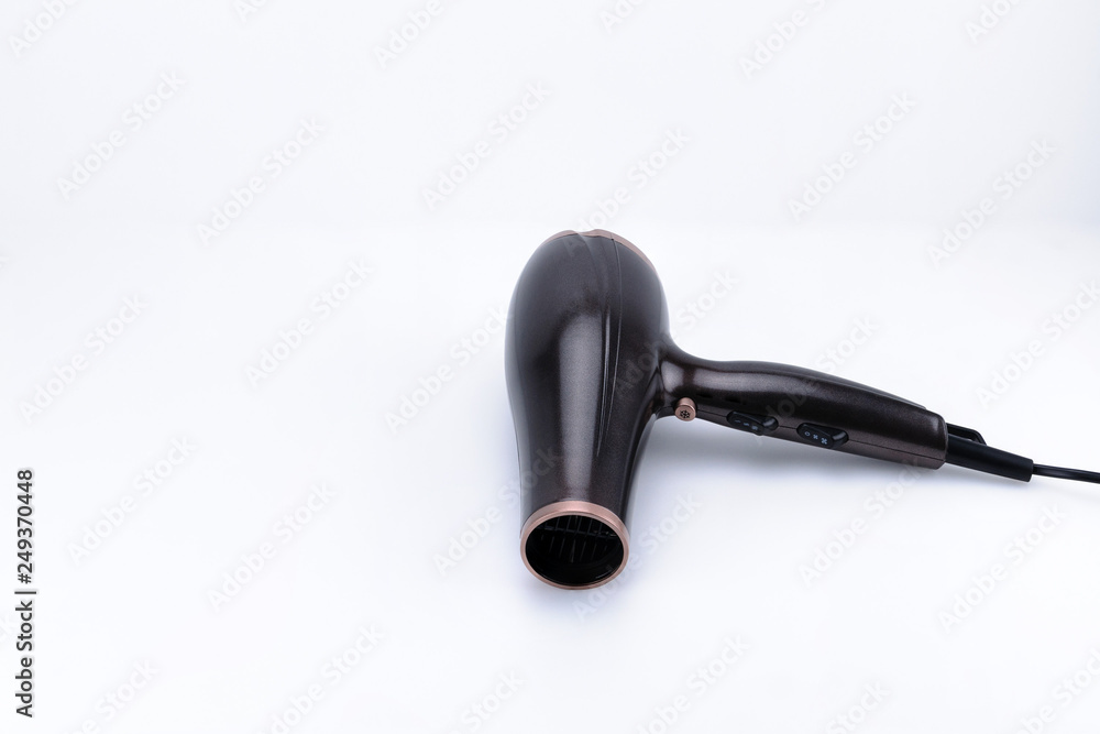 Brown glossy hair dryer on the white background with copy space Brown glossy hair dryer on the white background with copy space