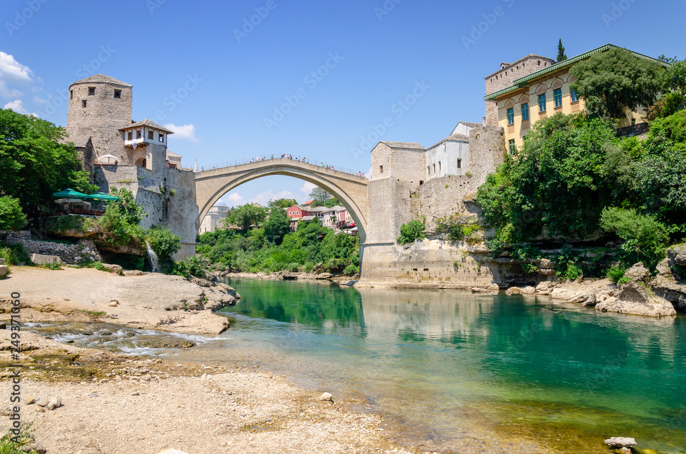 view on old bridge and emerald river Neretva in Mostar in Bosnia and Herzegovina view on old bridge and emerald river Neretva in Mostar in Bosnia and Herzegovina