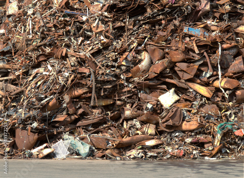 Iron scrap pile, red rust color, junk yard detail