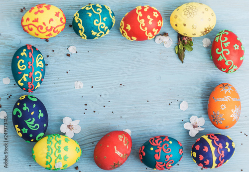 Easter eggs and spring flowers on wooden background