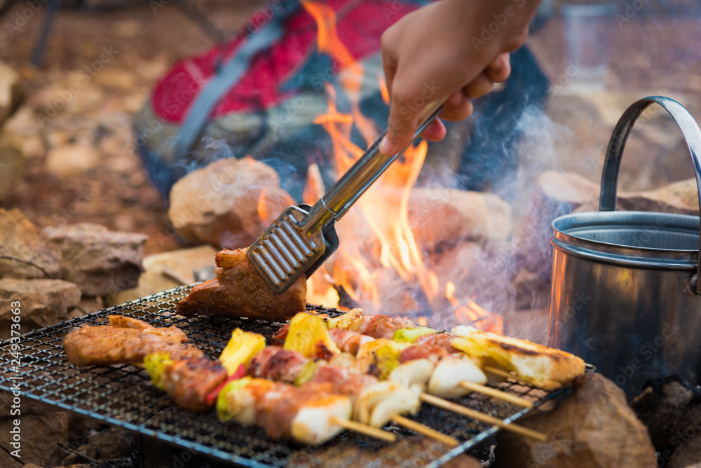 Close up grilling barbecue in the campground at summer camp travel