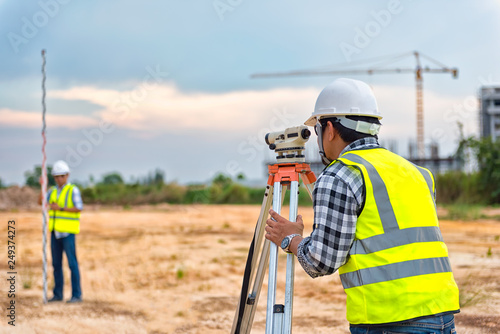 Surveyor equipment. Surveyor’s telescope at construction site or Surveying for making contour plans are a graphical representation of the lay of the land before startup construction work photo