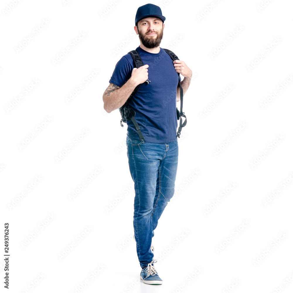 A man photographer in jeans and cap, black backpack goes walking looking on white background isolation A man photographer in jeans and cap, black backpack goes walking looking on white background isolation