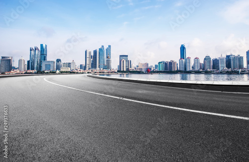 The expressway and the modern city skyline are in qingdao, China.